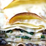 Layers of pasta with mushrooms, spinach, and bechamel sauce between each layer.