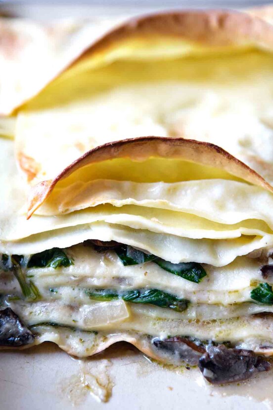 Layers of pasta with mushrooms, spinach, and bechamel sauce between each layer.