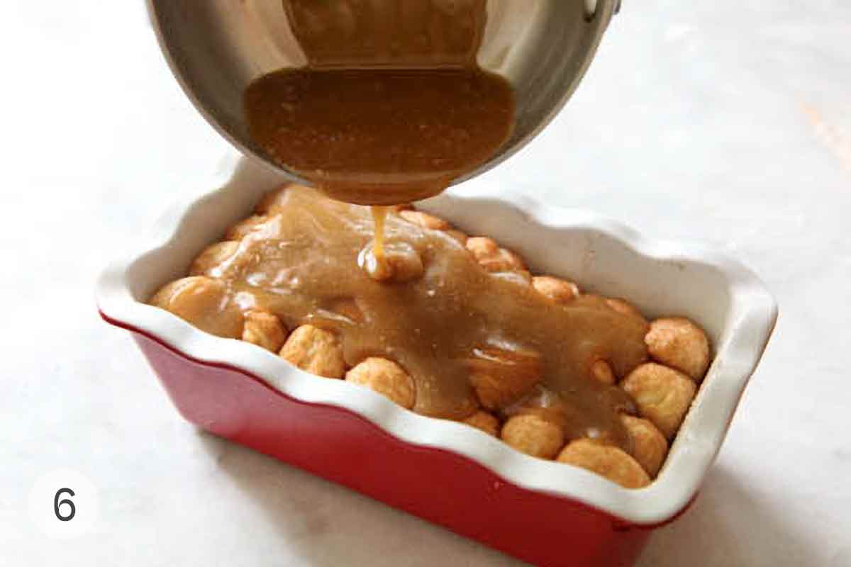 Caramel sauce being poured over unbaked monkey ball dough.