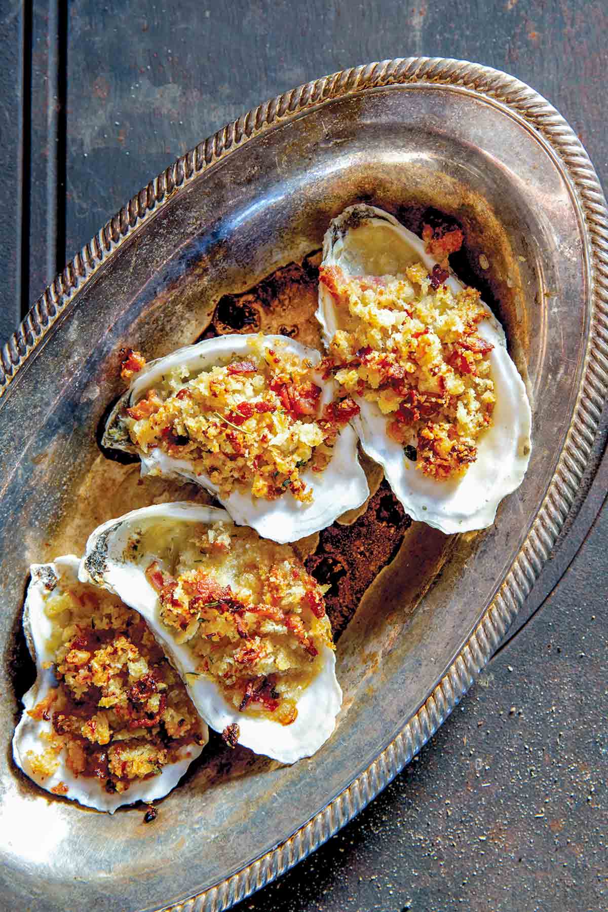 A tray of Rockefeller Oysters with Bacon - Baked oysters topped with breadcrumbs, bacon and butter.