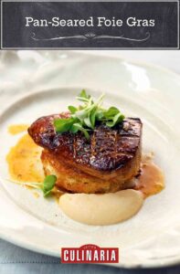 A plate with a large piece of seared foie gras topped with watercress and apple puree on the side.