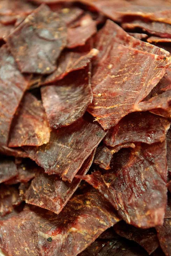A pile of thin slices of homemade beef jerky.