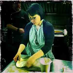 A woman working with dough.