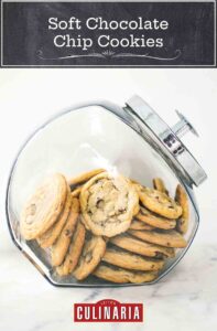 A jar filled with soft chocolate chip cookies.