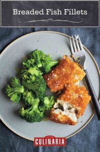wo pieces of breaded fish fillets sprinkled with salt on a grey plate with a portion of steamed broccoli and a fork.