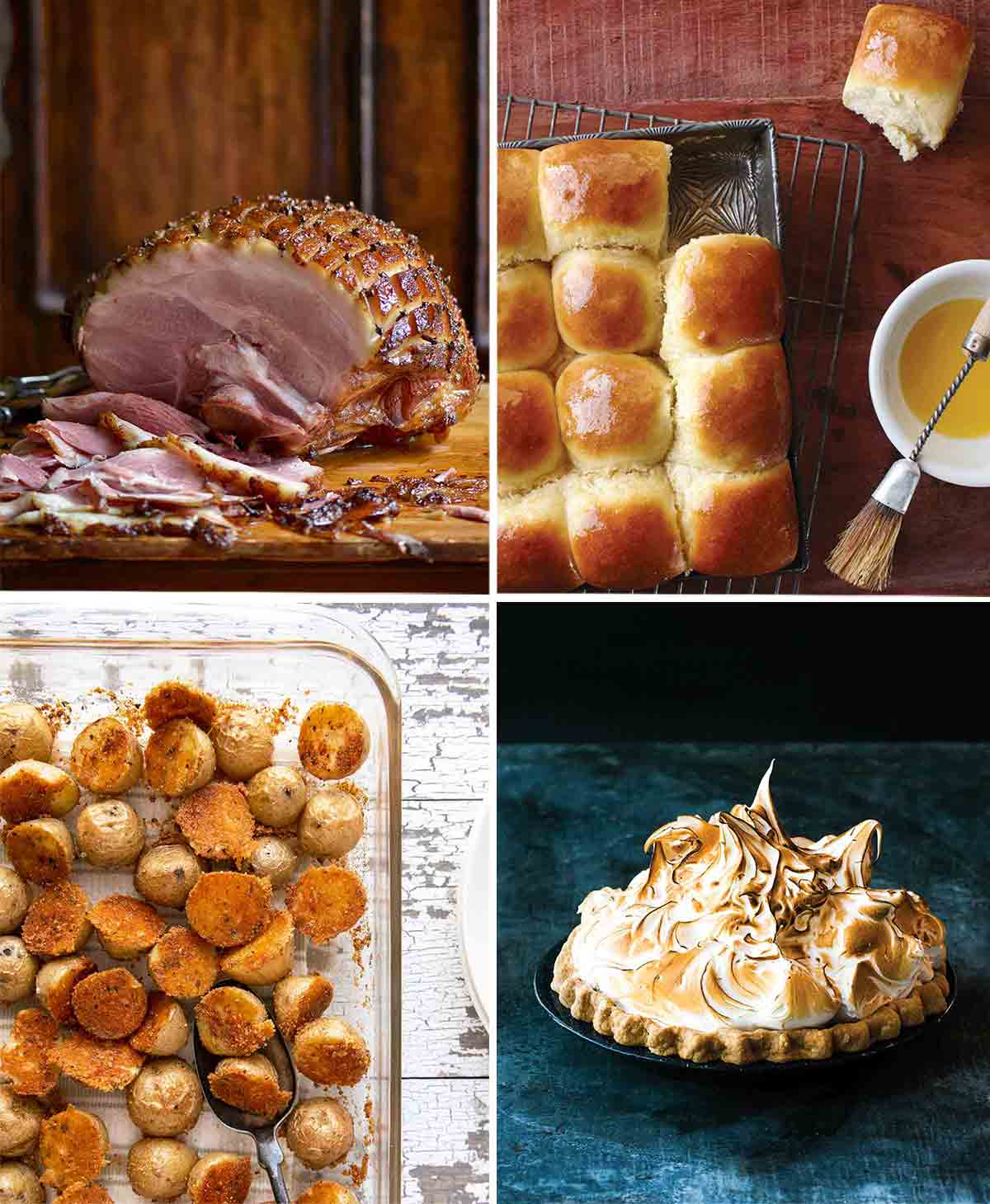 A glazed ham, and tray of dinner rolls, a baking dish filled with crispy potatoes, and a lemon meringue pie.