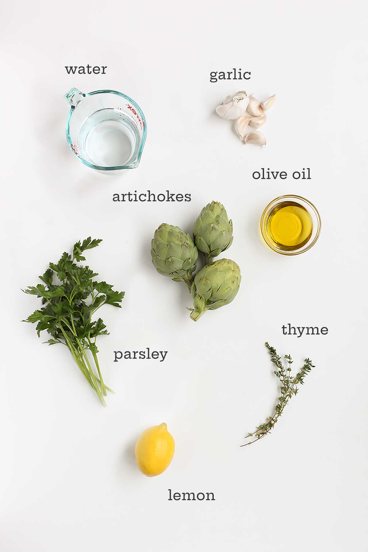 Ingredients for braised artichokes -- artichokes, parsley, thyme, lemon, garlic, oil, and water.