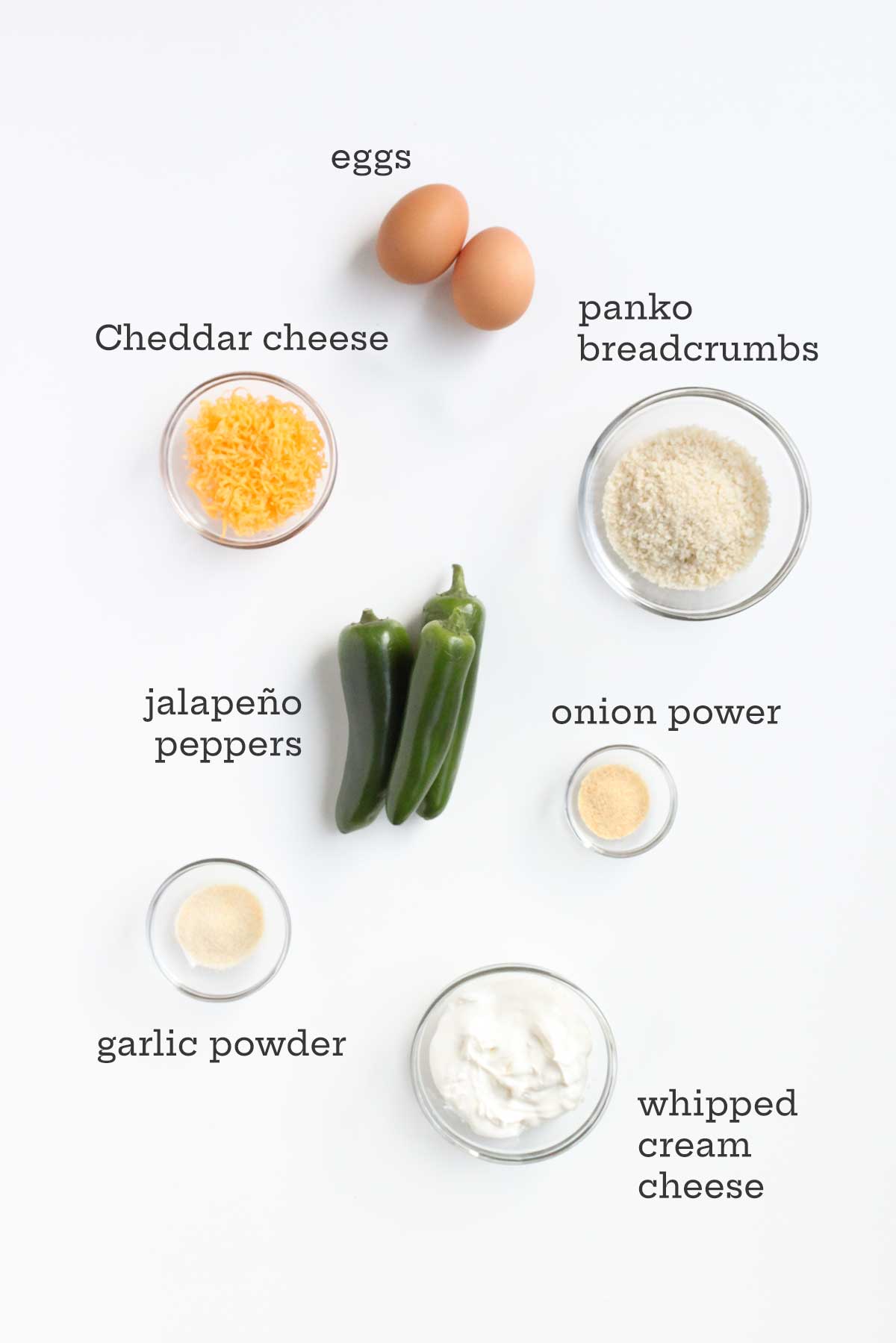 Ingredients for jalapeno poppers -- eggs, bread crumbs, Cheddar, jalapenos, onion and garlic powders, and whipped cream cheese.