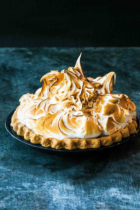 A lemon meringue pie topped with clouds of toasted meringue.
