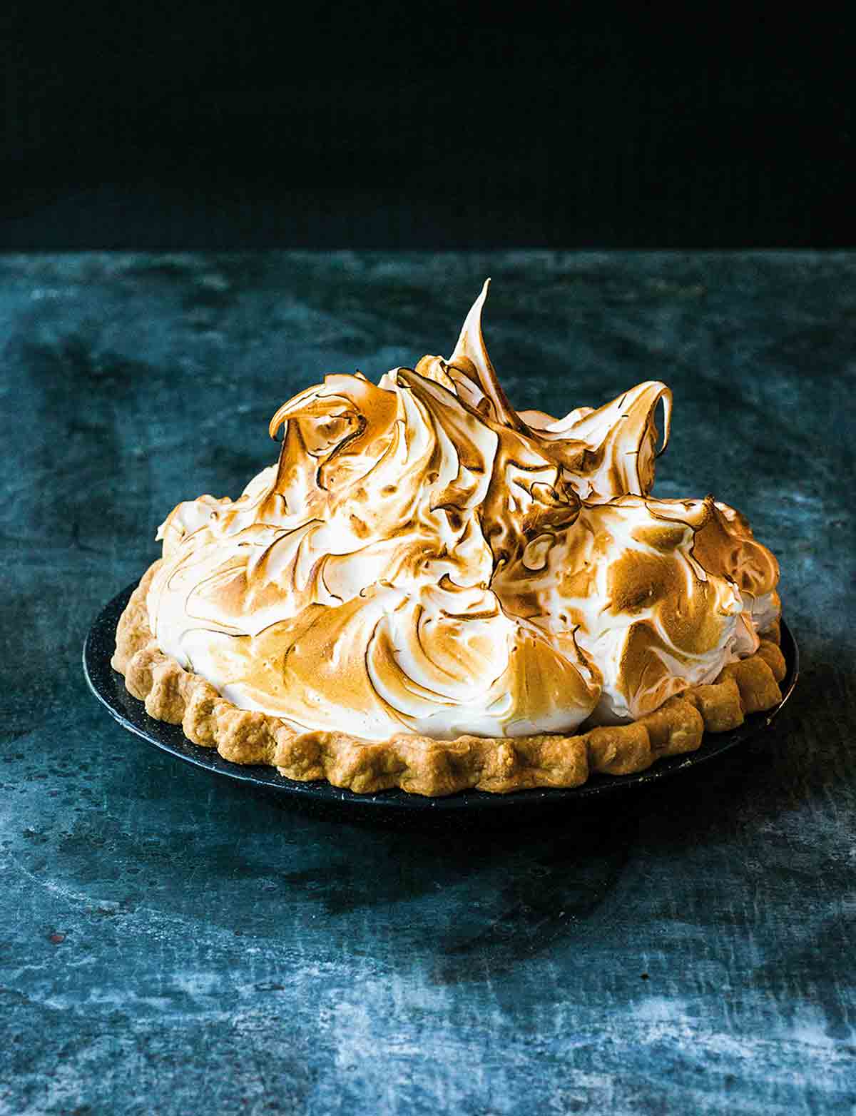 A lemon meringue pie topped with clouds of toasted meringue.