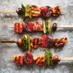 Four grilled vegetable skewers with harissa-marinated halloumi.