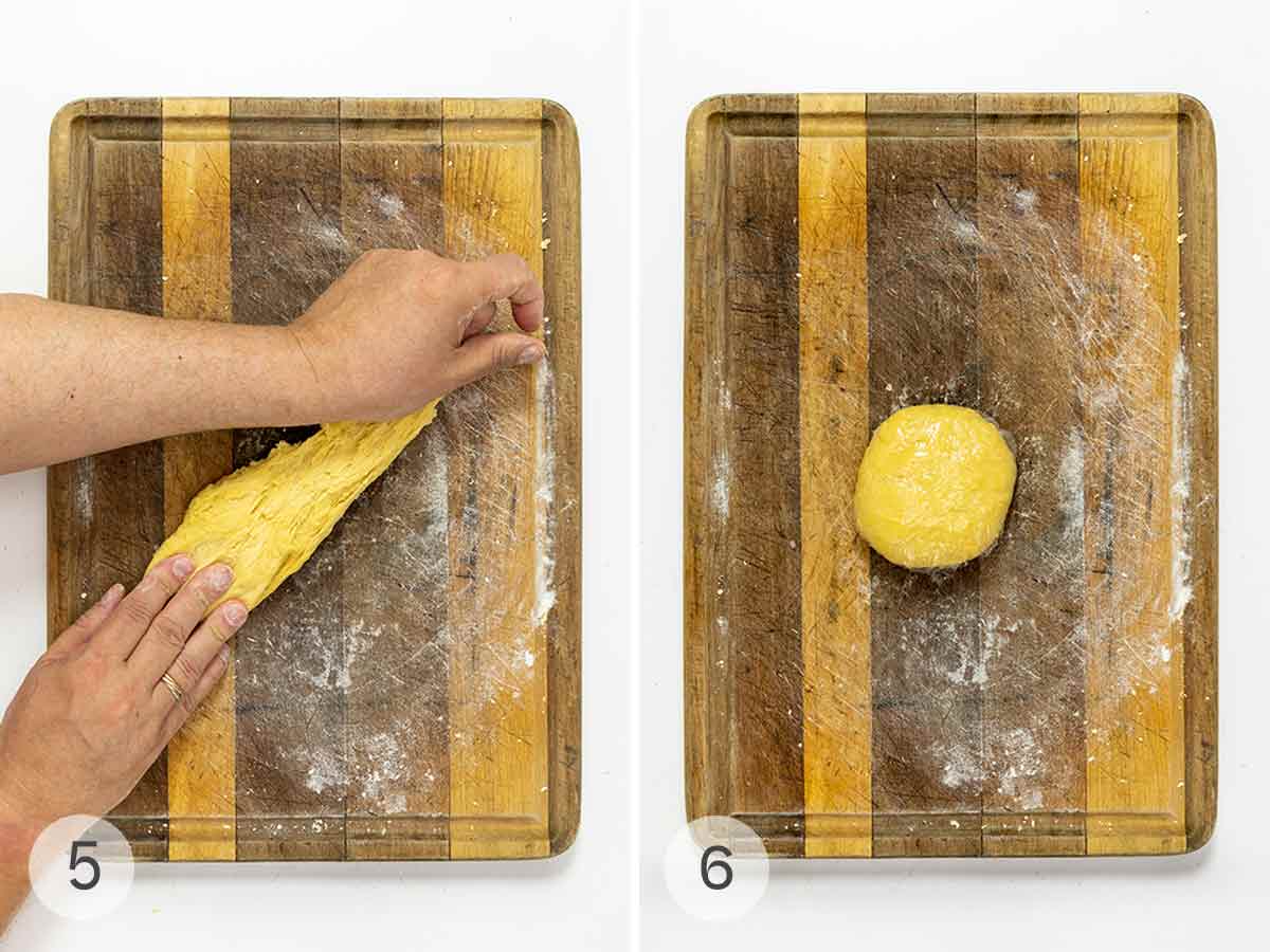A person kneading pasta dough on a wooden cutting board and a kneaded ball of dough wrapped in plastic.
