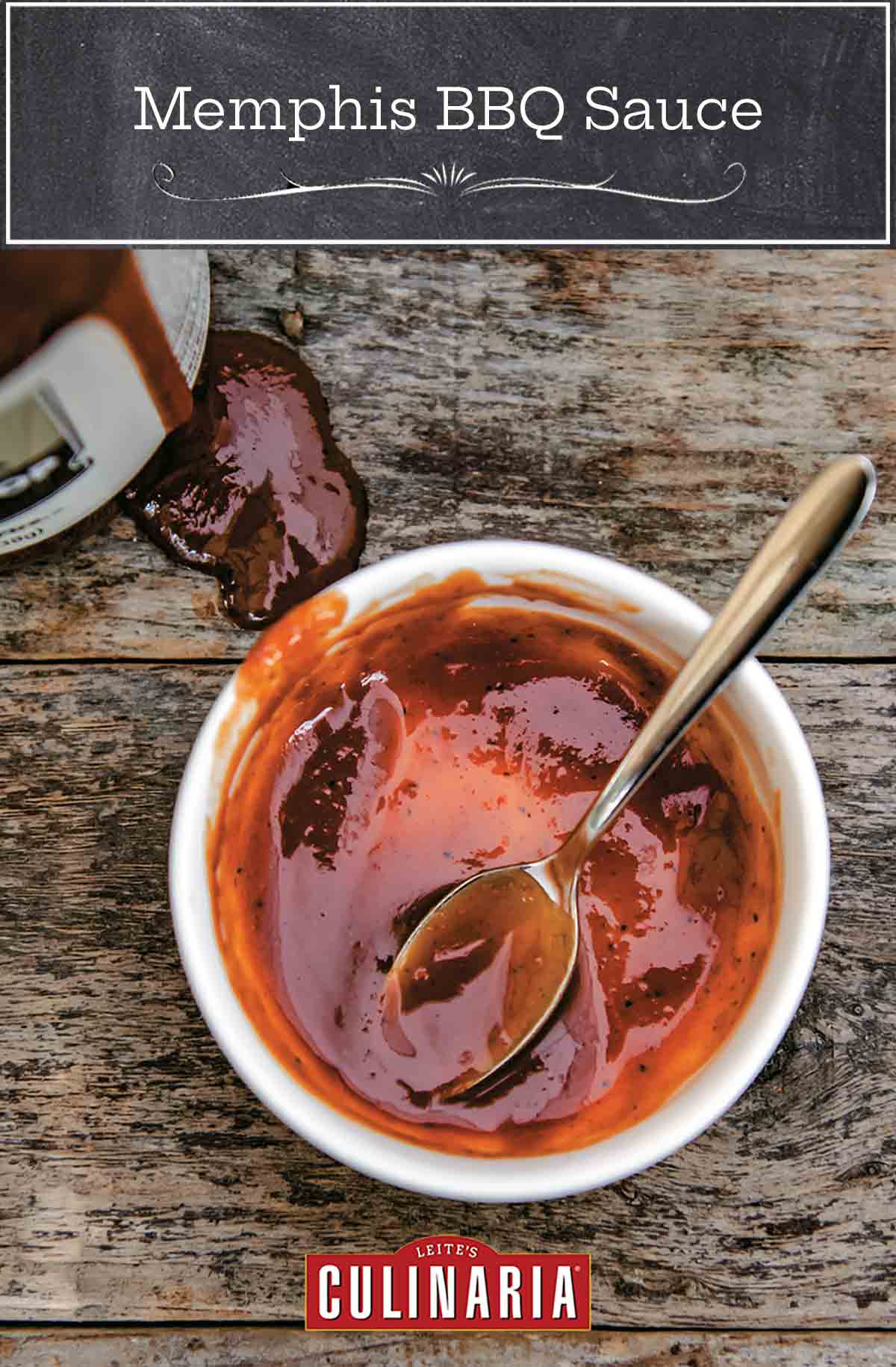 A white bowl with some Memphis BBQ mop sauce and a spoon in it with a bottle of sauce on the side.