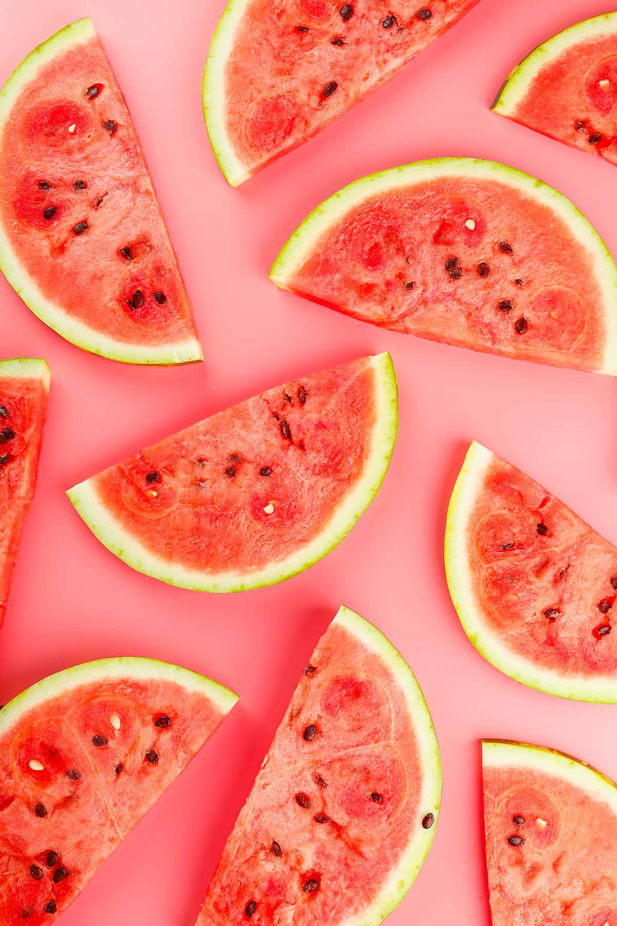 Slices on watermelon on a pink background