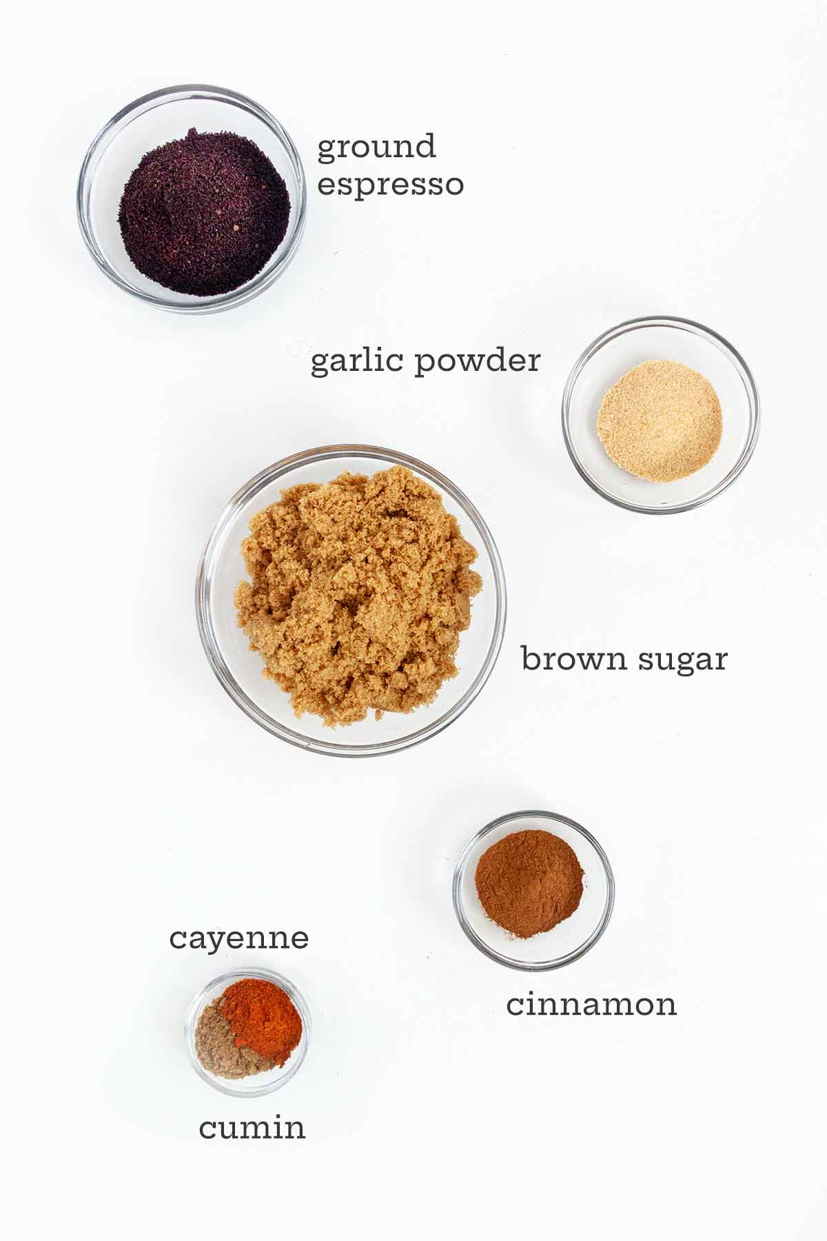 Ingredients for bbq dry rub -- ground espresso, garlic powder, brown sugar, cinnamon, cumin, and cayenne.