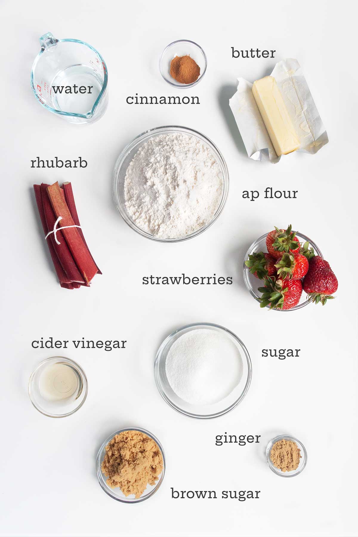 Ingredients for strawberry rhubarb pie--rhubarb, berries, flour, butter, sugar, water, vinegar, cinnamon, and ginger.