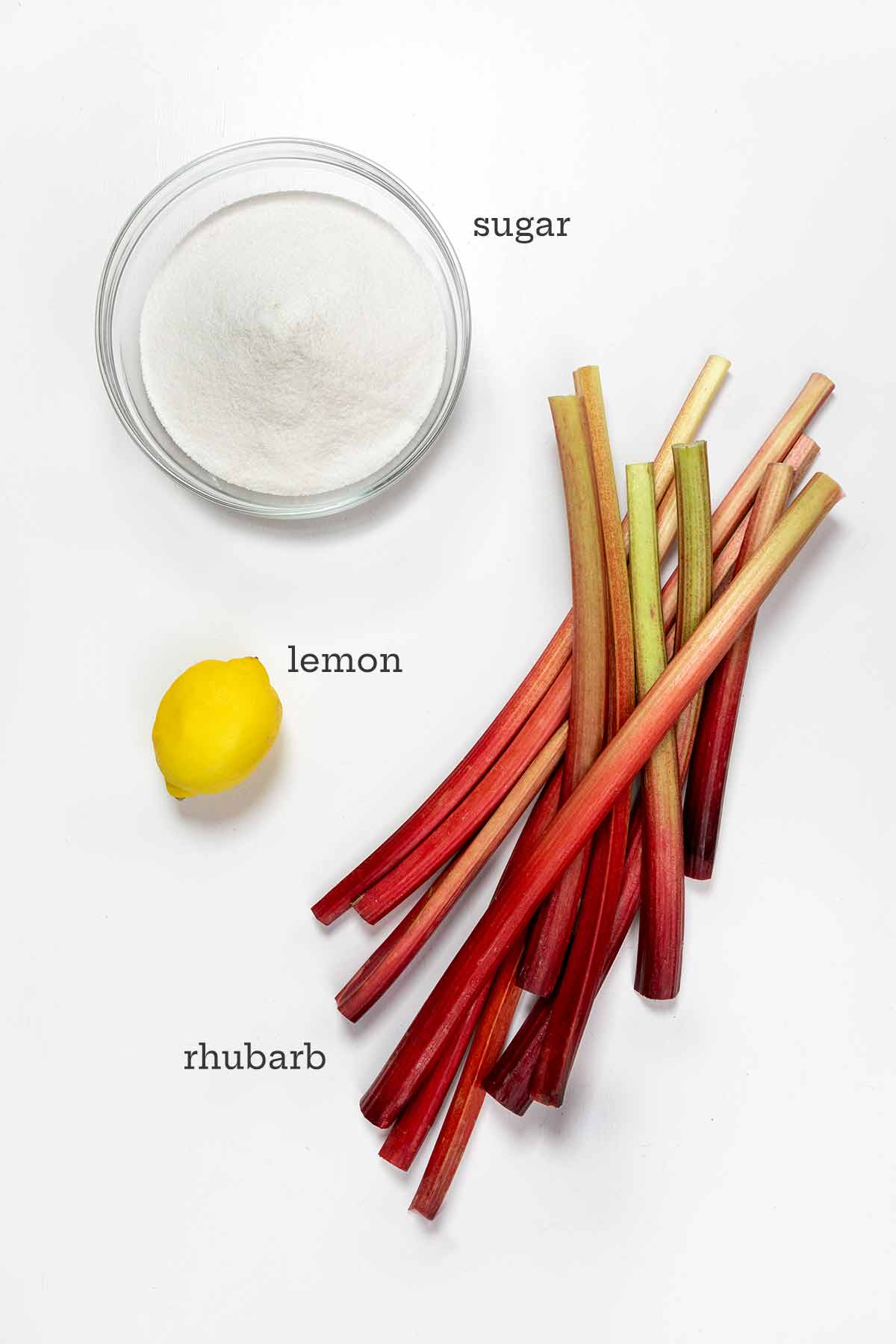 Ingredients for rhubarb jam -- sugar, lemon, and rhubarb.
