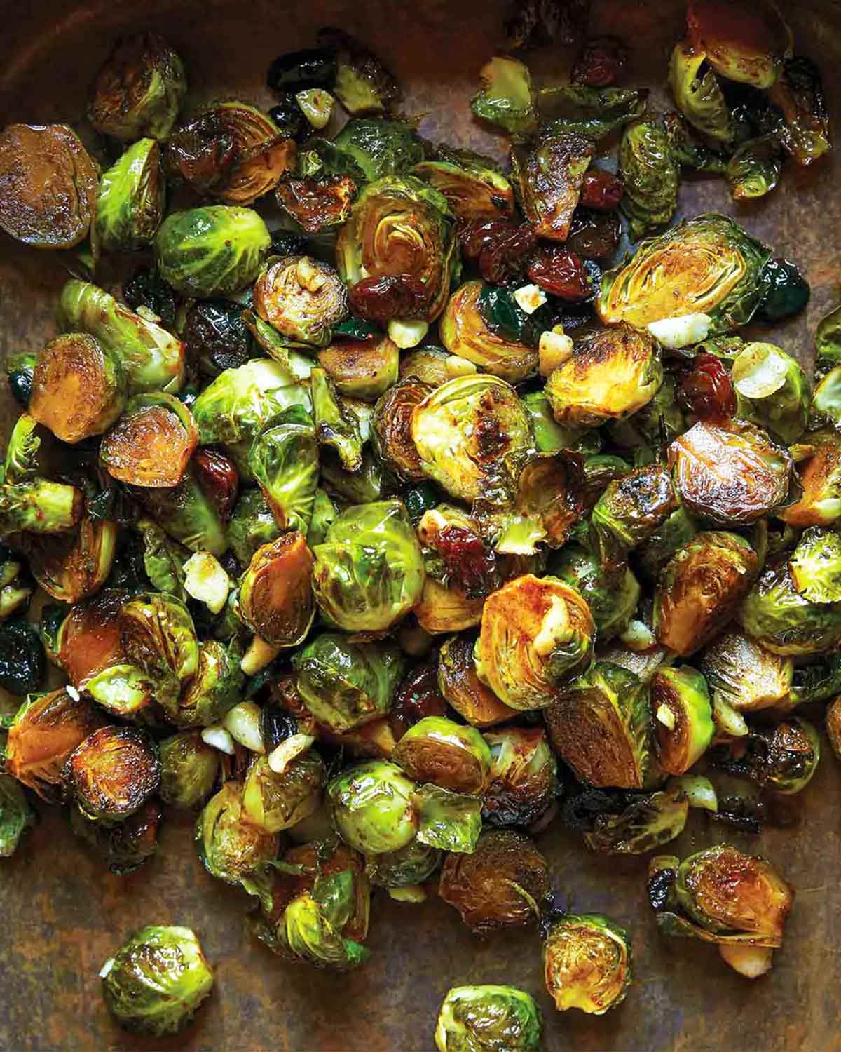 A pile of roasted Brussels sprouts on a baking sheet.