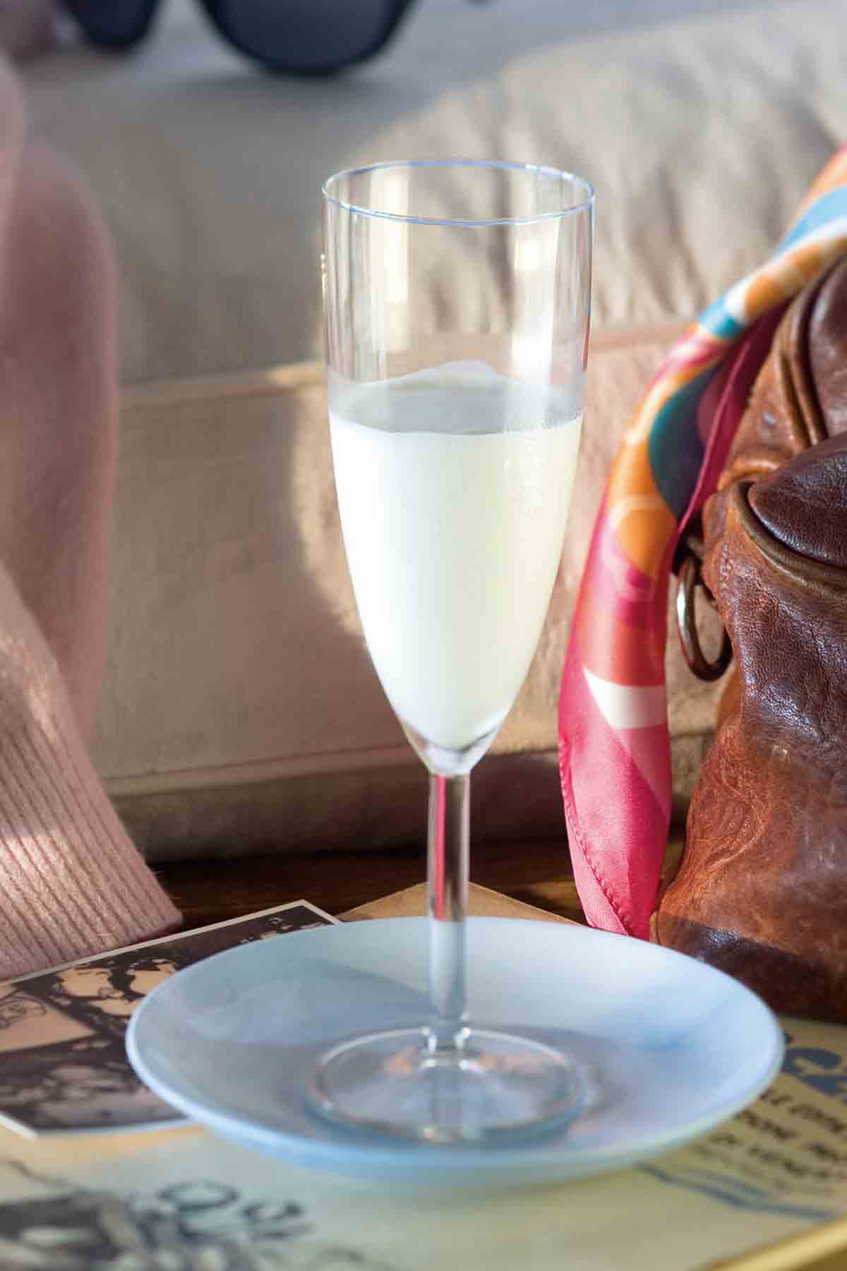 A champagne glass of Sgroppino, also called Lemon Chill, on a blue plate.