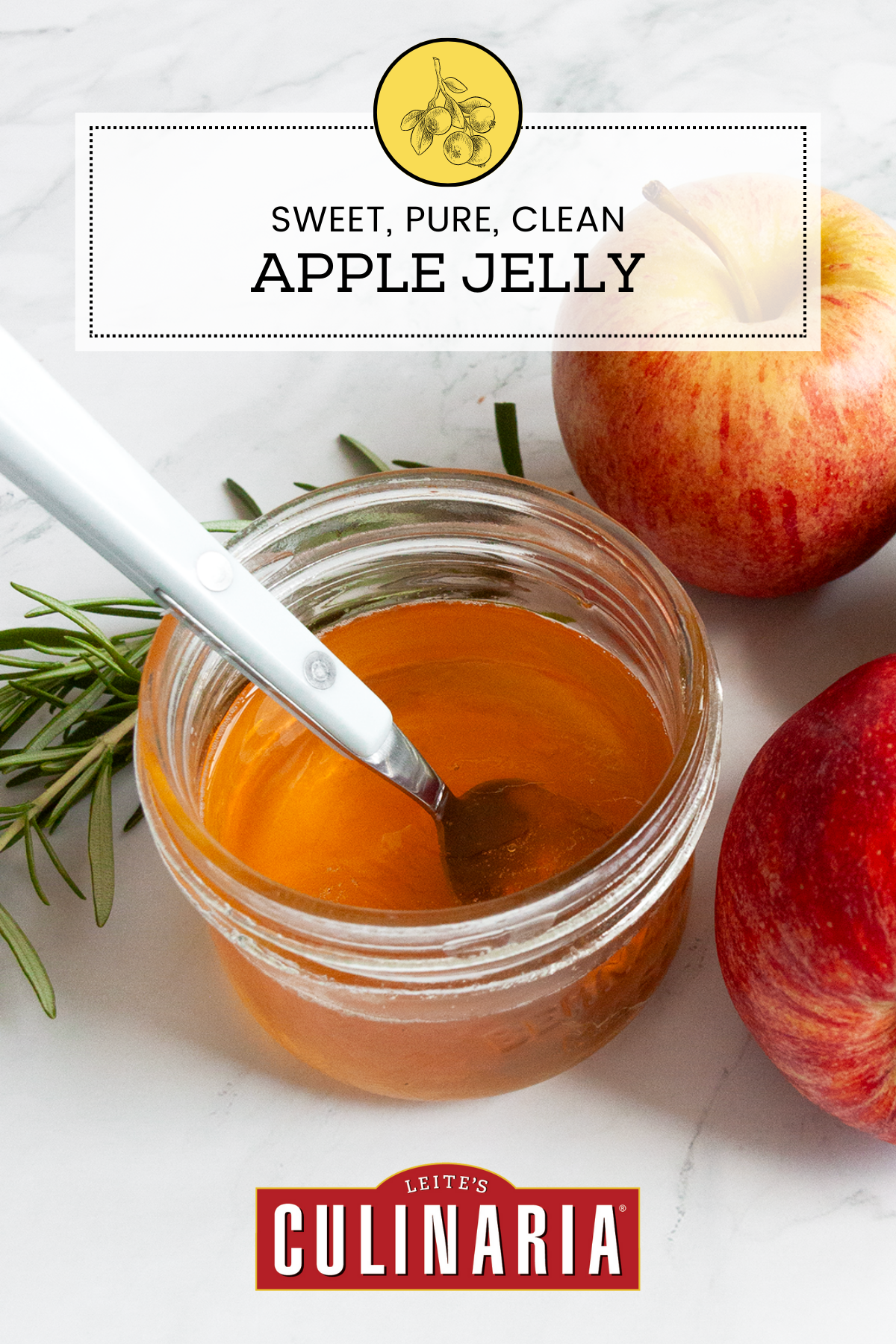 A jar of apple jelly with a spoon resting inside and a three apples on the side.