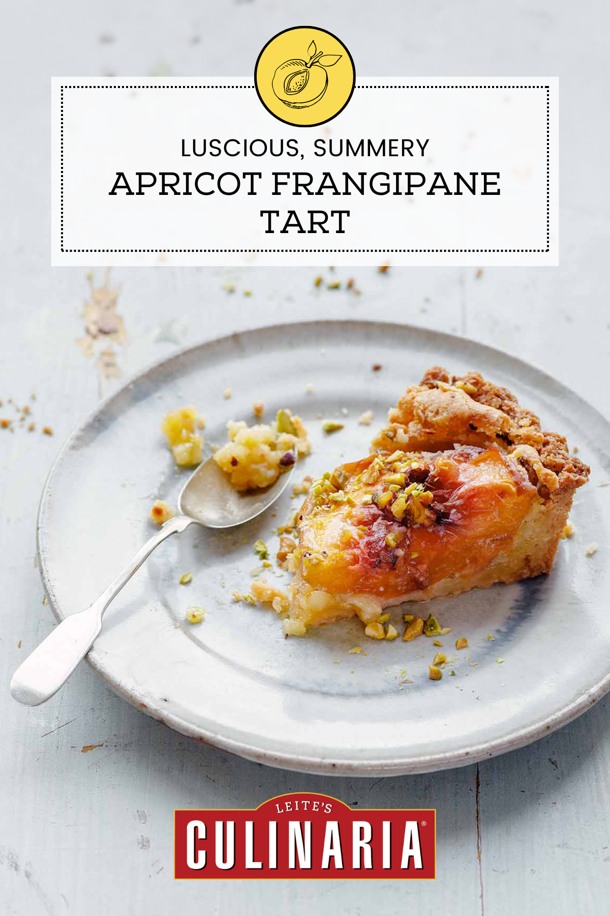 Plate with an slice of apricot tart filled with frangipane and topped with chopped pistachios.