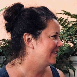 A woman in profile smiling.