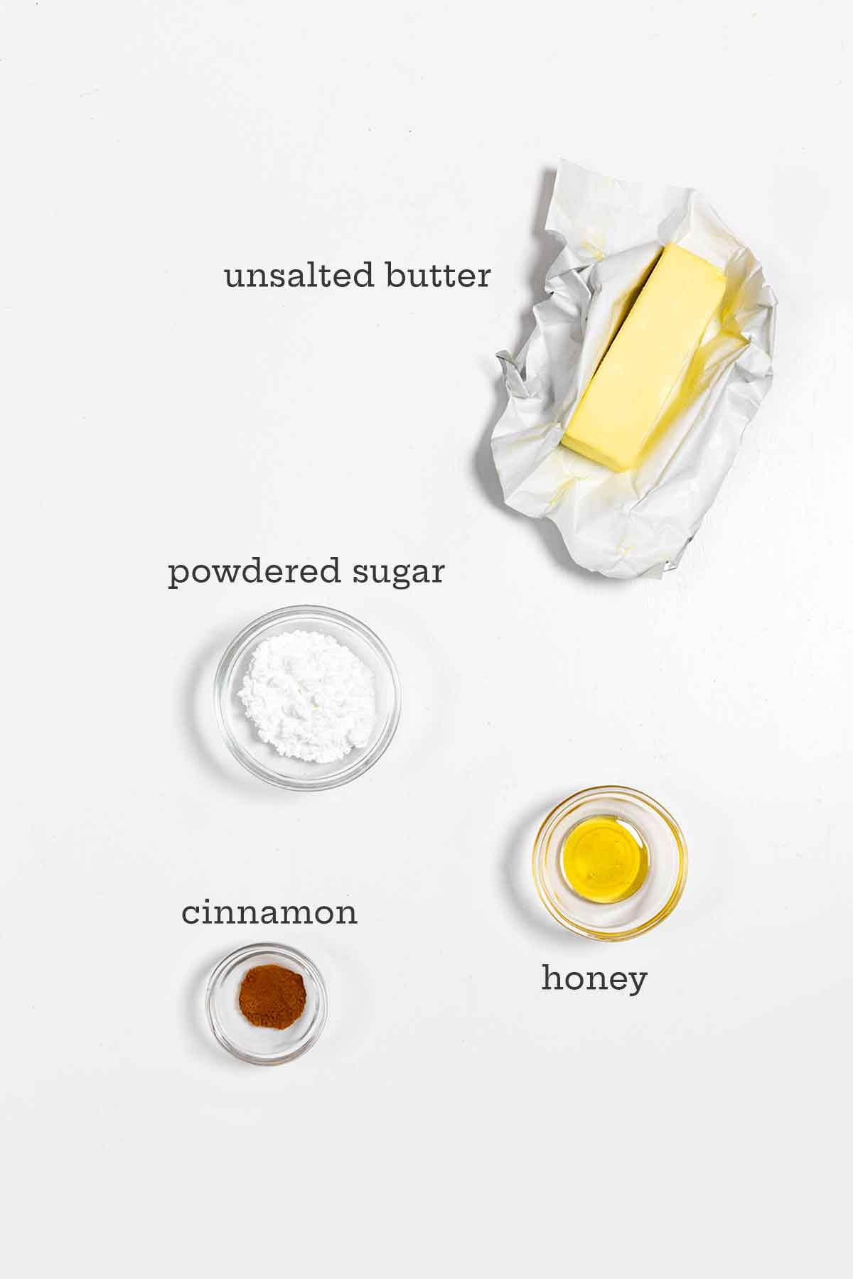 Ingredients for cinnamon butter--unsalted butter, powdered sugar, cinnamon, and honey.