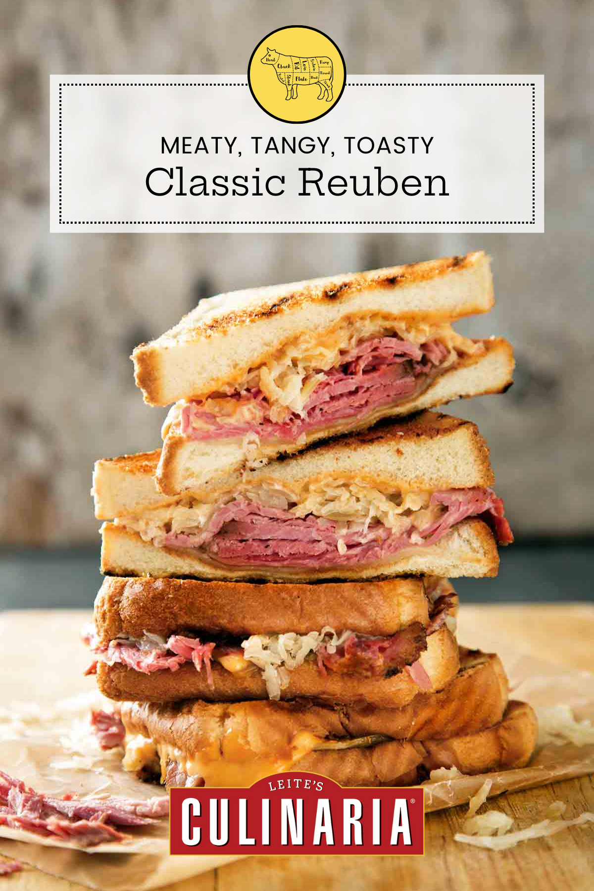 A stack of halved reuben sandwiches on a wooden cutting board.