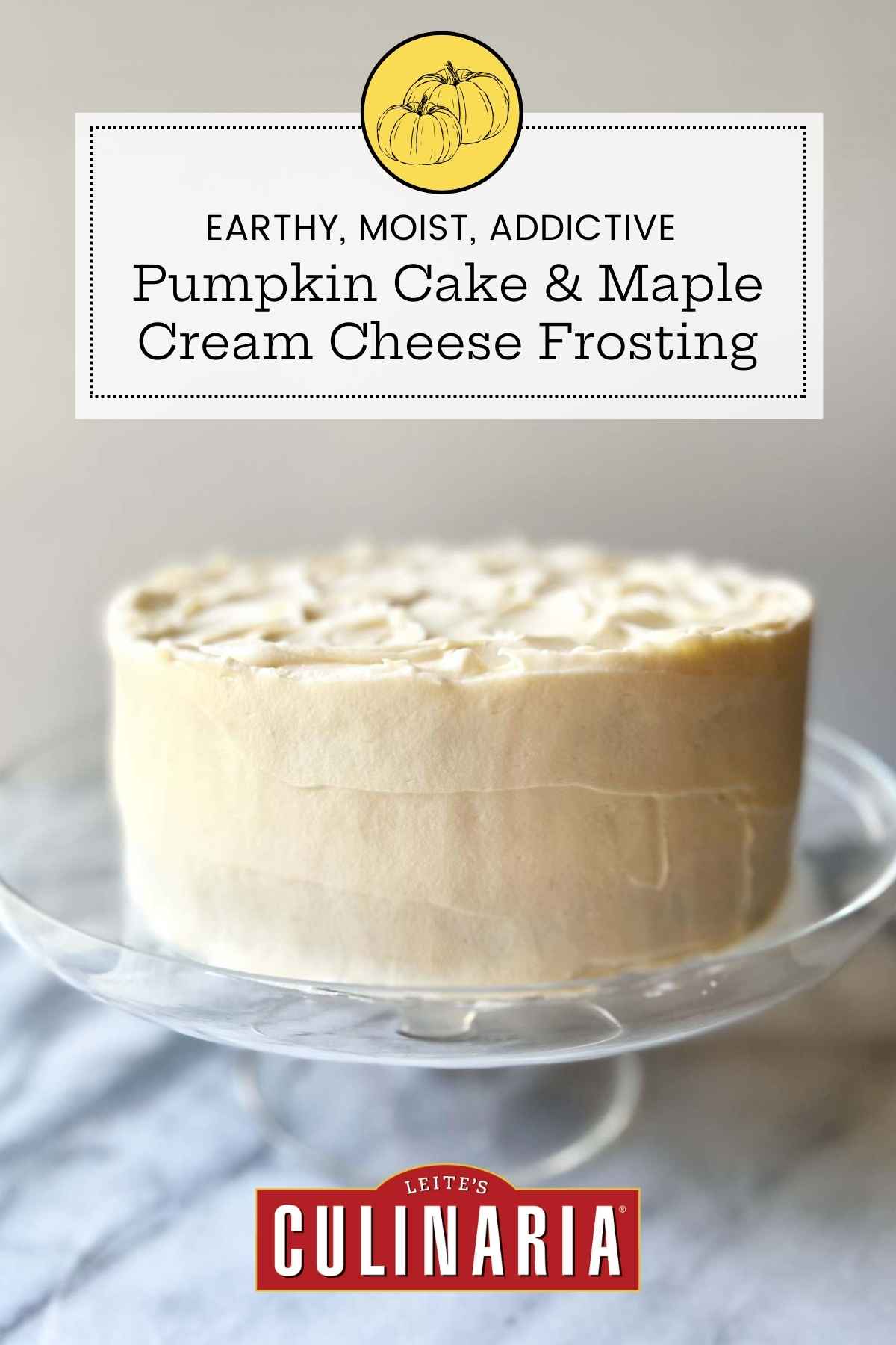 A pumpkin cake with maple-cream cheese frosting on a cake stand.