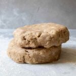 Two disks of whole wheat pie crust dough stacked one on top of the other.