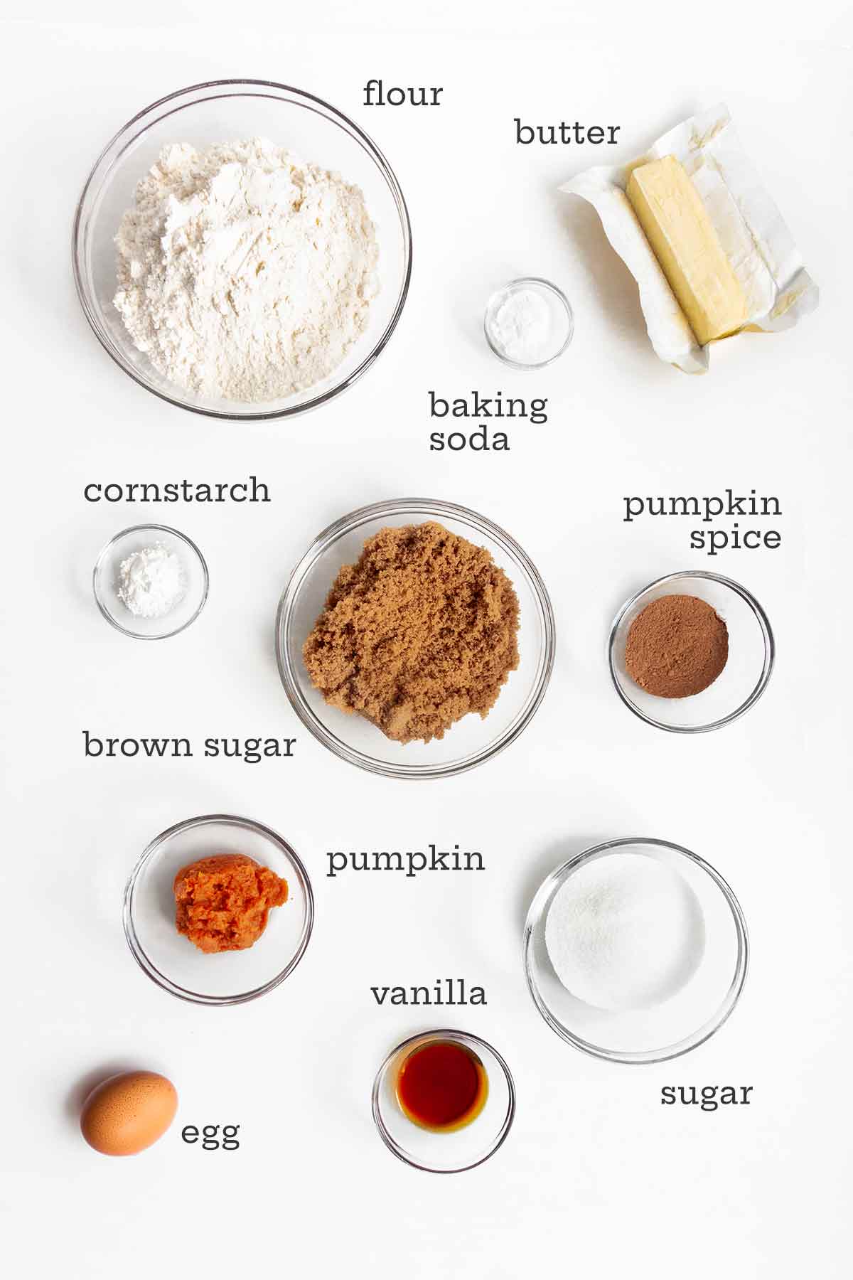Ingredients for pumpkin spice cookies--pumpkin, spices, sugar, flour, butter, egg, baking soda, and cornstarch.