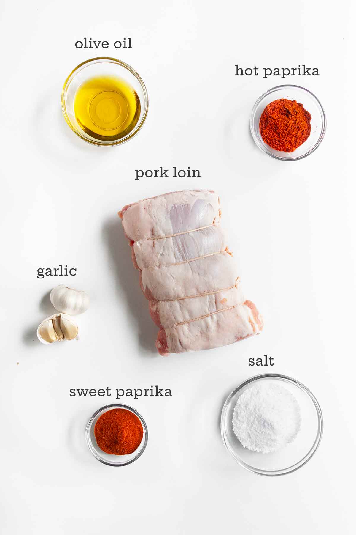 Ingredients for Spanish pork loin roast--pork loin, oil, hot and sweet paprika, garlic, and salt.