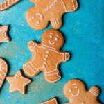 A selection of decorated gingerbread cookies in the shapes of men, stars, and trees.