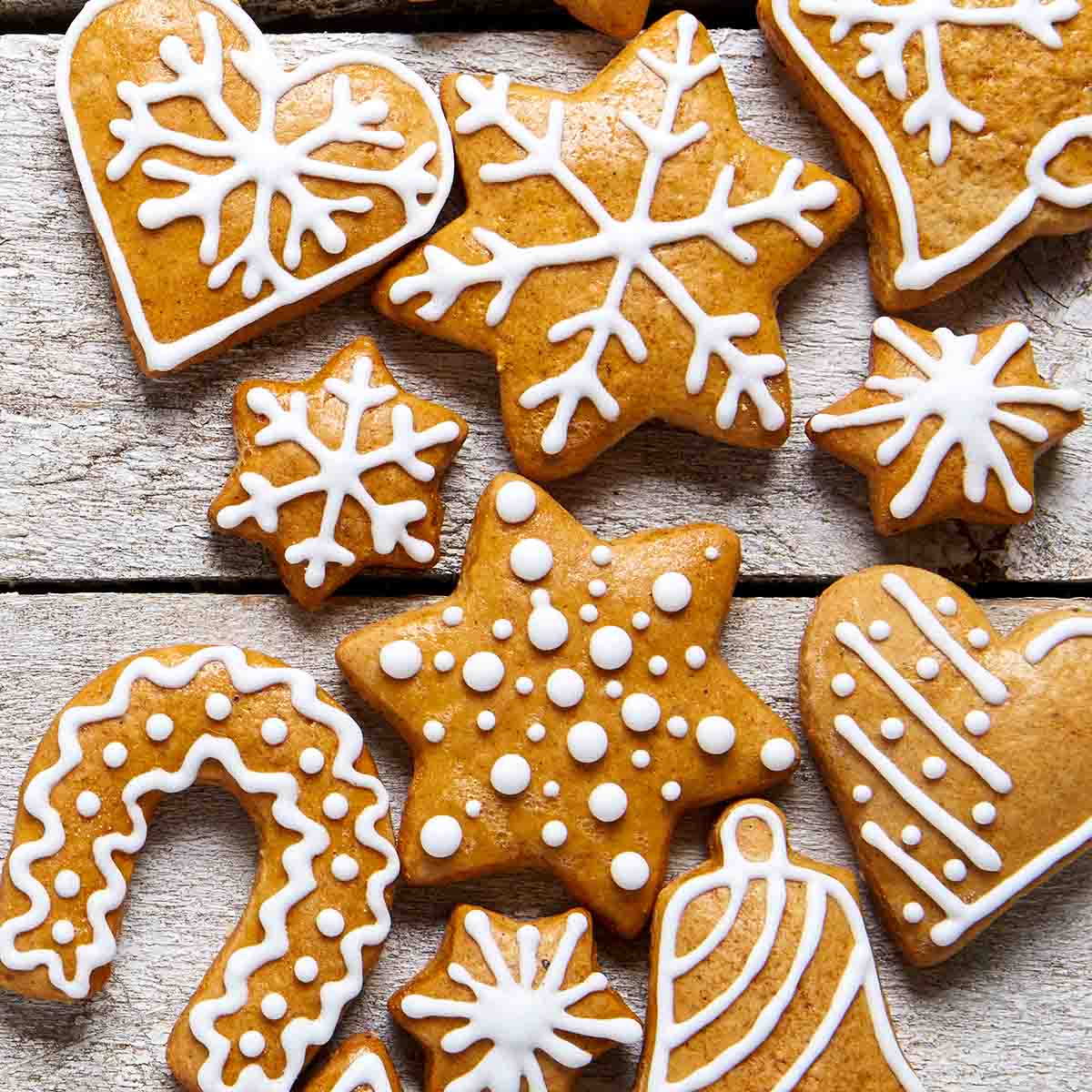 A variety of iced gingersnaps cookies cut into different shapes.