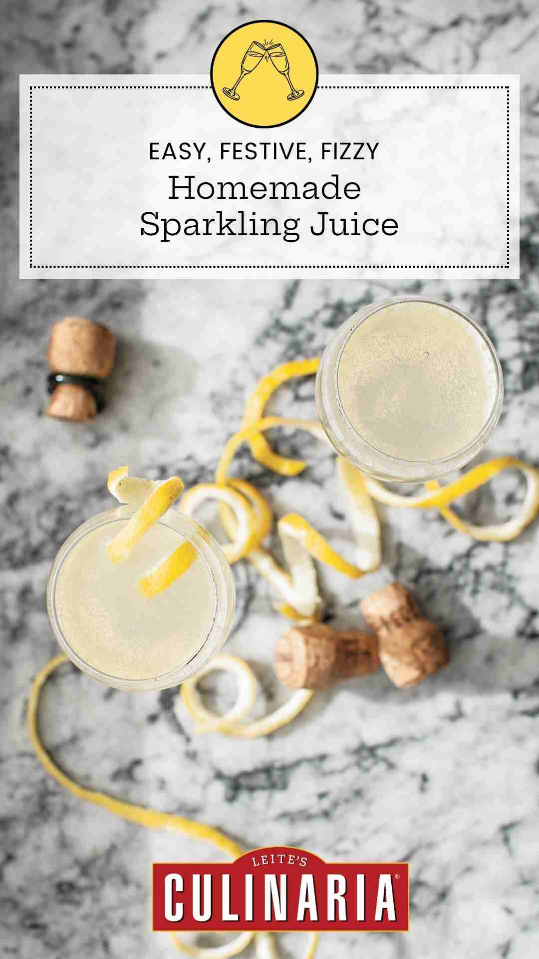 Two flutes filled with homemade sparkling juice topped with lemon twists on a marble surface.