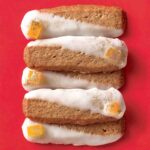 Pain d'Épices Cookies stacked in a pile of five glazed and garnished with candied orange peel.