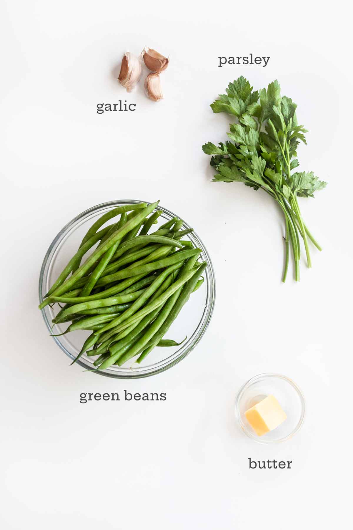 Ingredients for pan-fried green beans--beans, parsley, garlic, and butter.