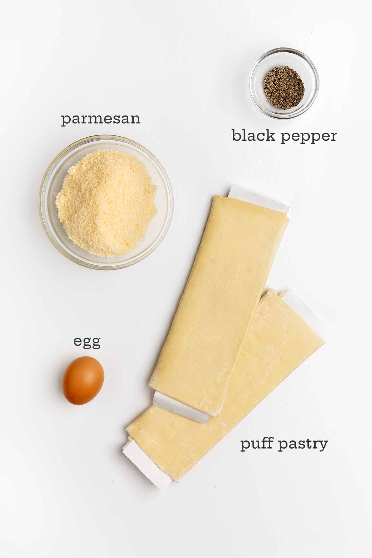 Ingredients for peppery cheese straws--Parmesan, puff pastry, pepper, and egg.