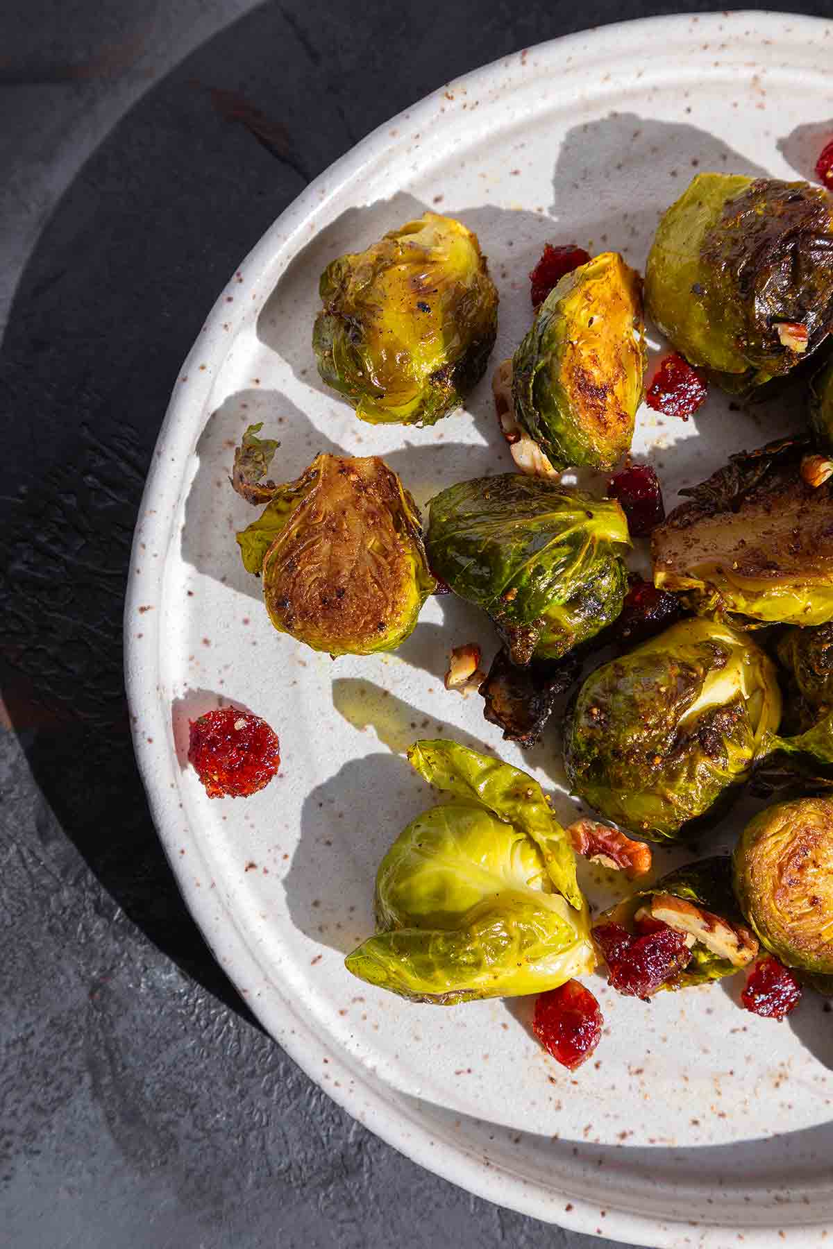 Roasted Brussels sprouts and cranberries on a plate.