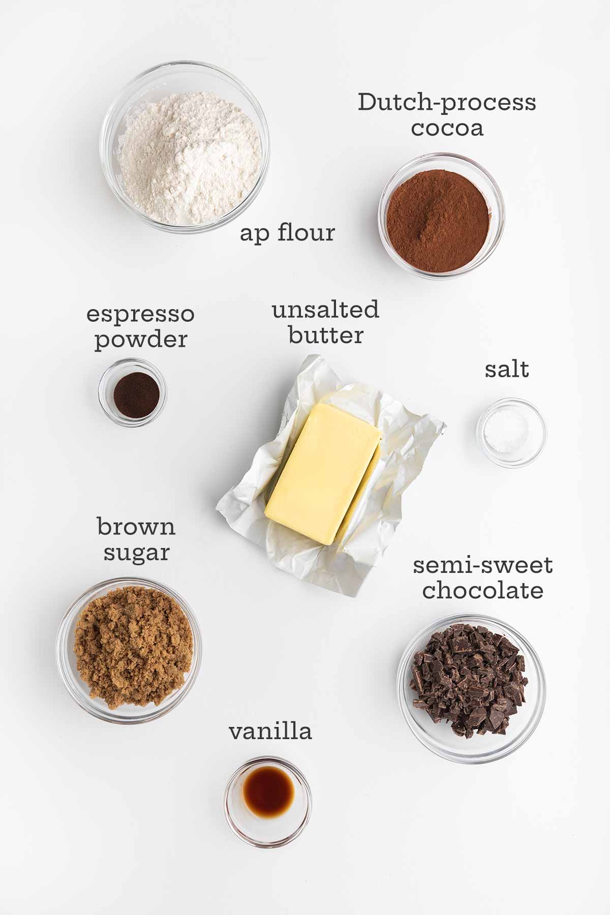 Ingredients for chocolate espresso shortbread cookies--flour, cocoa, butter, salt, espresso powder, brown sugar, semi-sweet chocolate, and vanilla.