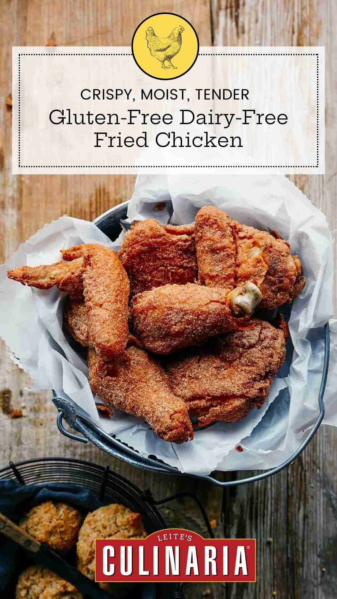 Several pieces of gluten-free dairy-free fried chicken in a parchment-lined metal bucket.