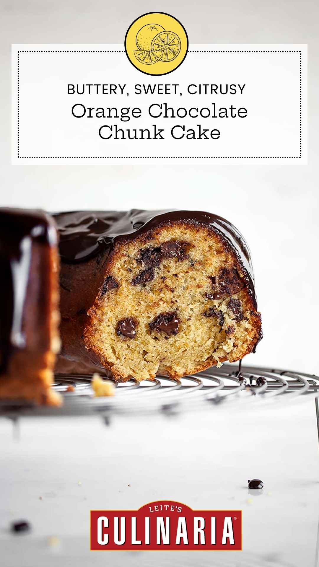 A partially cut orange chocolate chunk cake on a round wire rack.