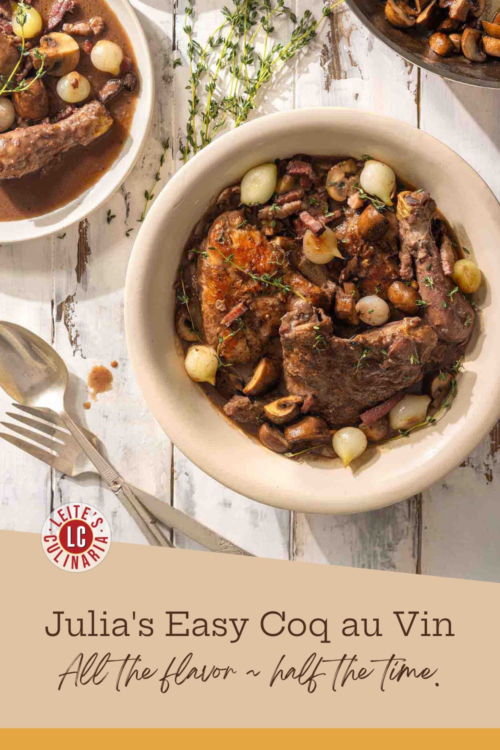 A Dutch oven filled with coq au vin, a rustic chicken stew with pearl onions and mushrooms.