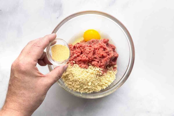 Ground beef, panko, and egg in a bowl.