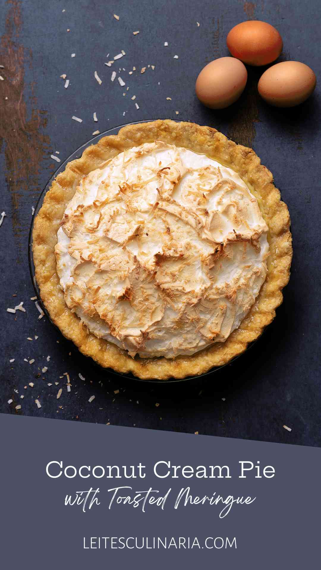 A coconut cream pie with a meringue top and sprinkled with toasted shredded coconut.