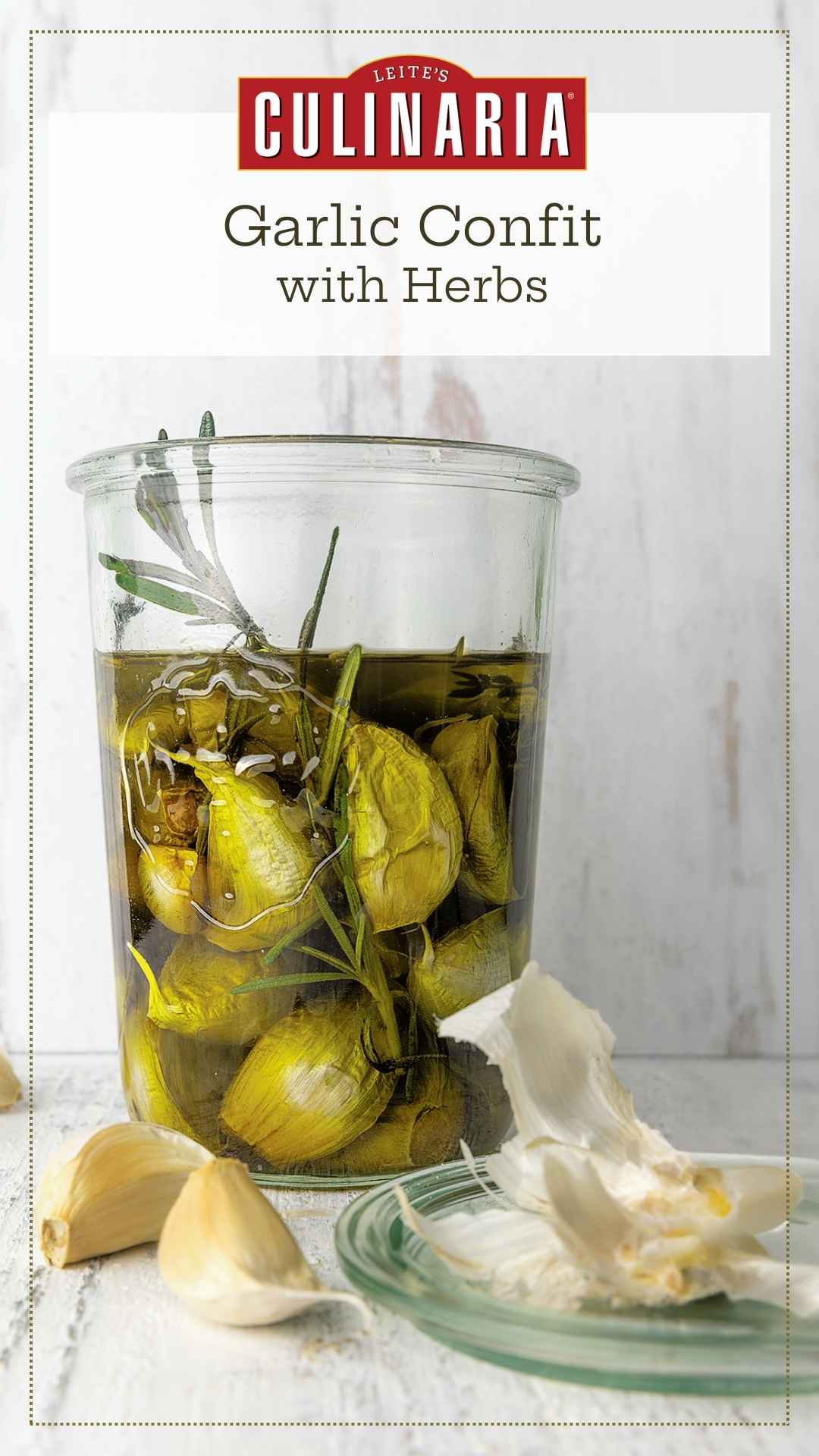 A jar of garlic confit with loose garlic cloves and husks nearby.