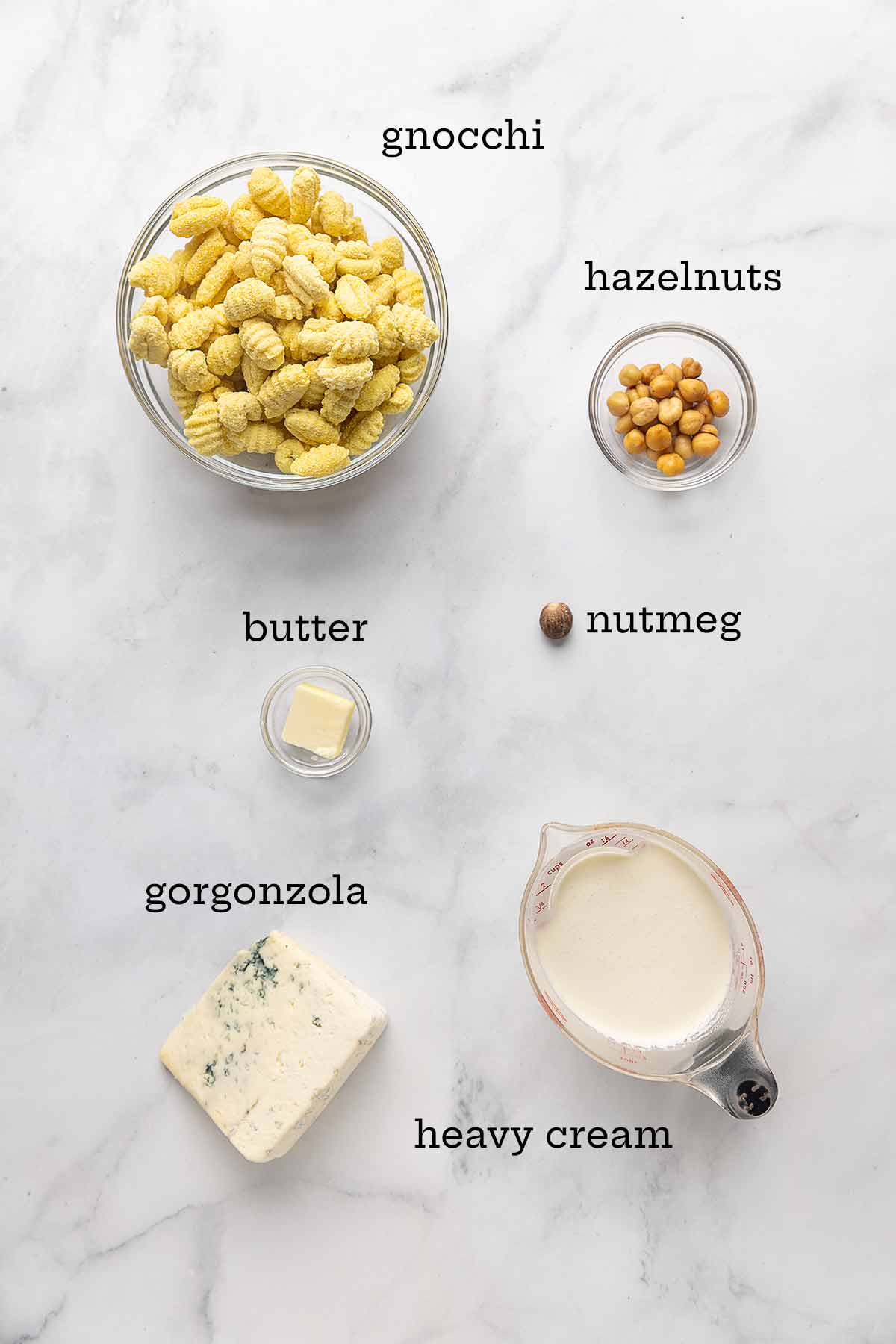 Ingredients for gnocchi with gorgonzola cream sauce--gnocchi, hazelnuts, butter, nutmeg, gorgonzola, and heavy cream.