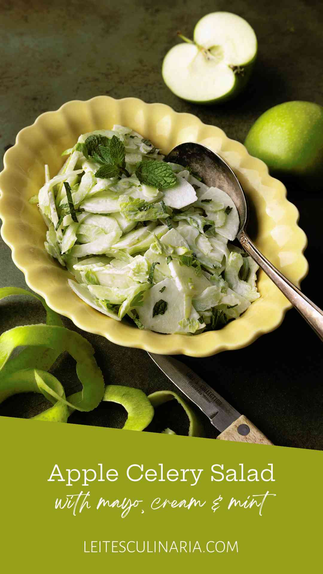 An apple and celery salad in a creamy dressing, garnished with mint leaves in a yellow scalloped bowl.