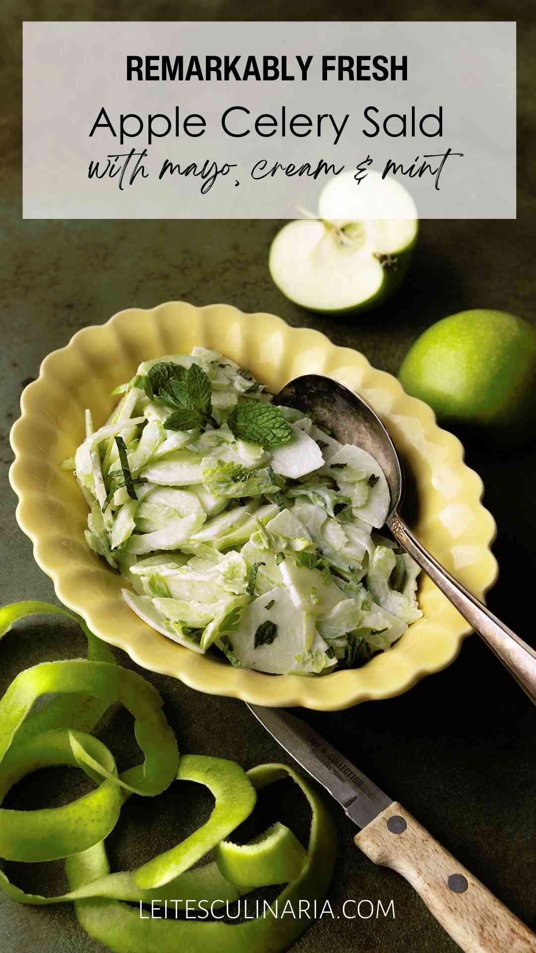 An apple and celery salad in a creamy dressing, garnished with mint leaves in a yellow scalloped bowl.