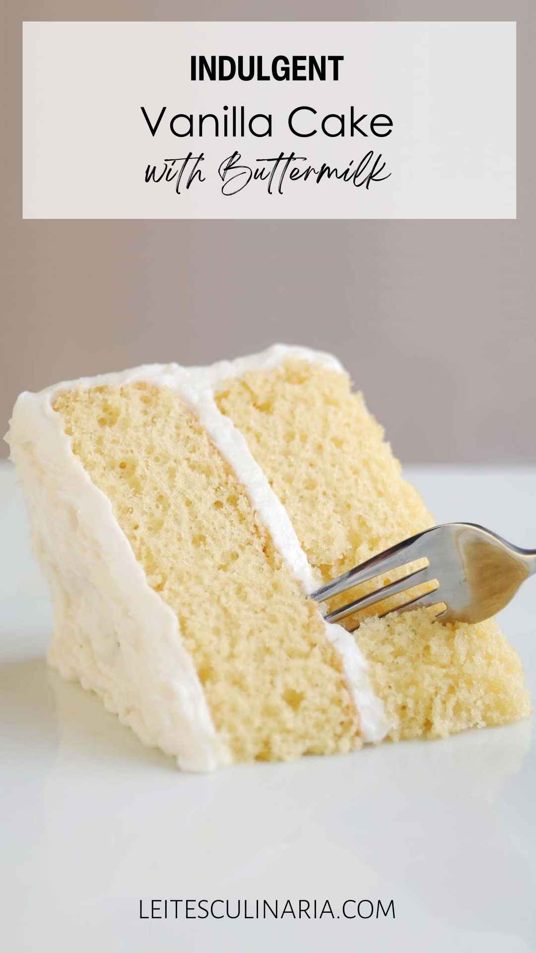 A slice of two-layer white cake with white frosting.